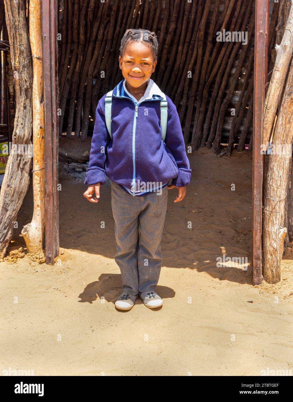 back to school, african kid in uniform posing outdoors in the yard before she go to the village school Stock Photo