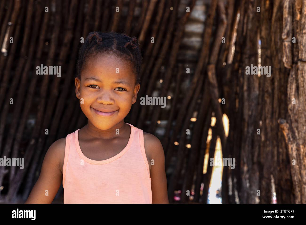 african girl standing in front of the outdoors kitchen in the yard, village in Botswana Stock Photo