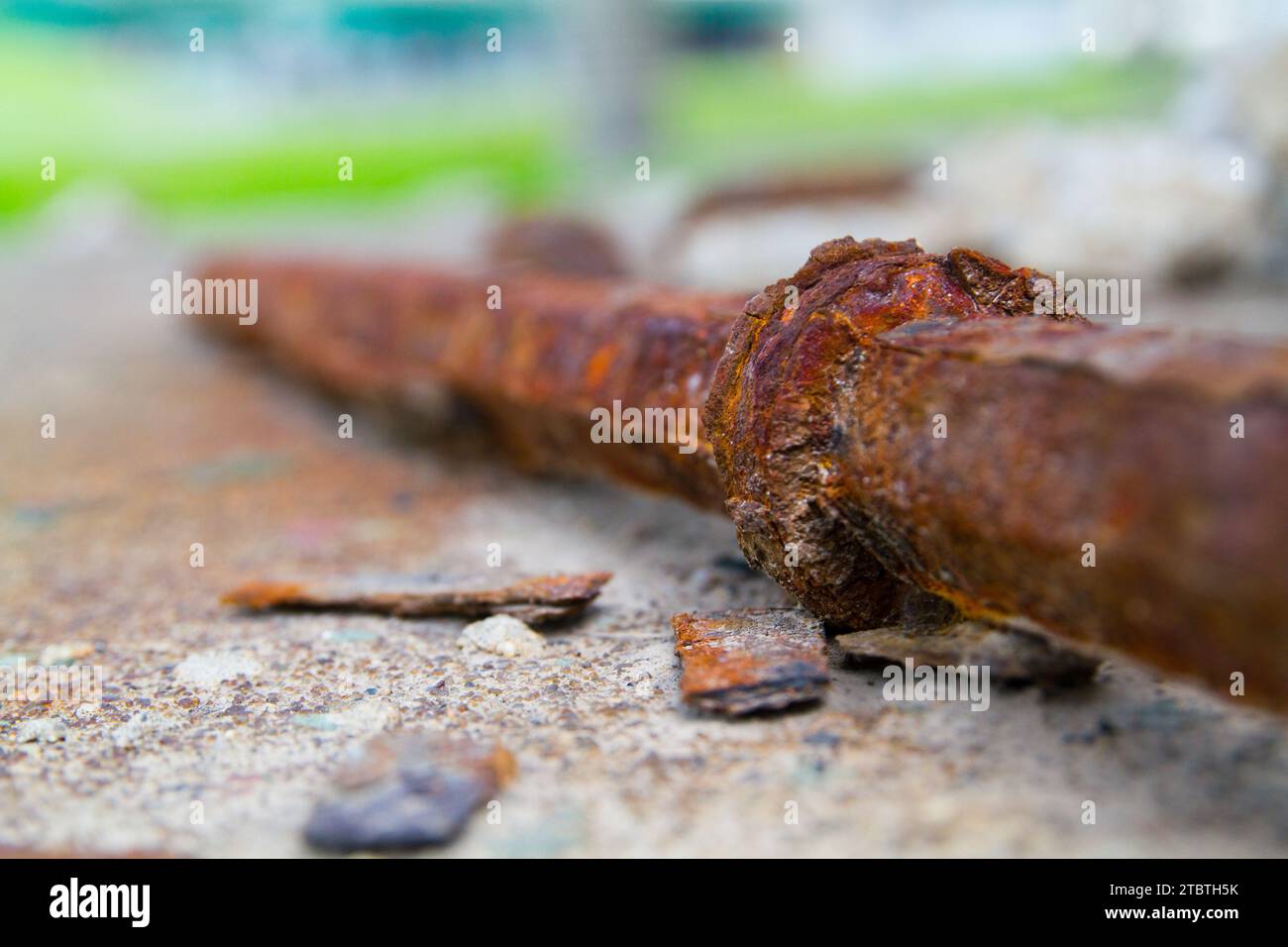 Close-Up of Rusted Metal Rod on Concrete in Urban Outdoors Stock Photo