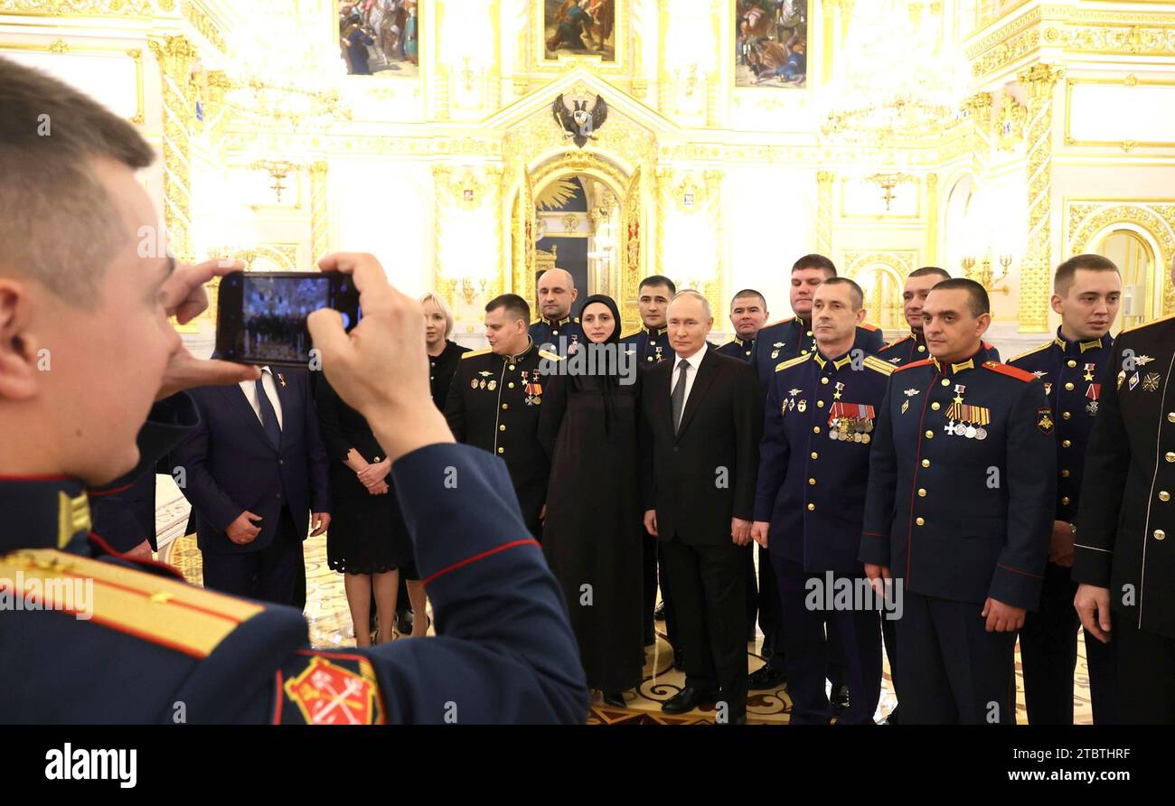 Moscow, Russia. 08th Dec, 2023. Russian President Vladimir Putin, centers, stands with Gold Star heroes during a reception on the eve of Heroes of the Fatherland Day at St. George Hall of the Grand Kremlin Palace, December 8, 2023 in Moscow, Russia. Credit: Mikhail Klimentyev/Kremlin Pool/Alamy Live News Stock Photo