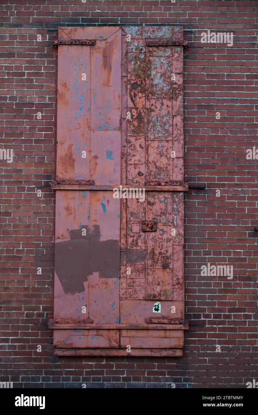 Decaying Red Door in Urban Brick Wall, Louisville Stock Photo