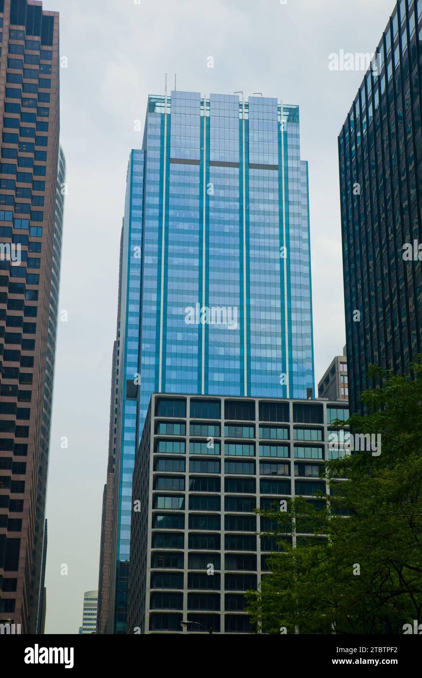 Urban Canyon: Glass Skyscraper Amid High-Rises in Chicago's Business District Stock Photo