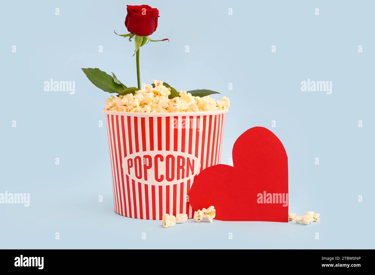 Popcorn At Roses Bucket of popcorn with beautiful rose and paper heart on blue ...