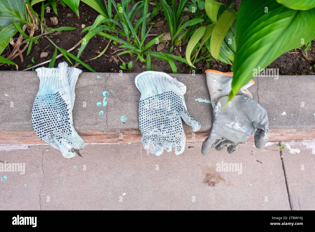 three work gloves worn from use Stock Photo