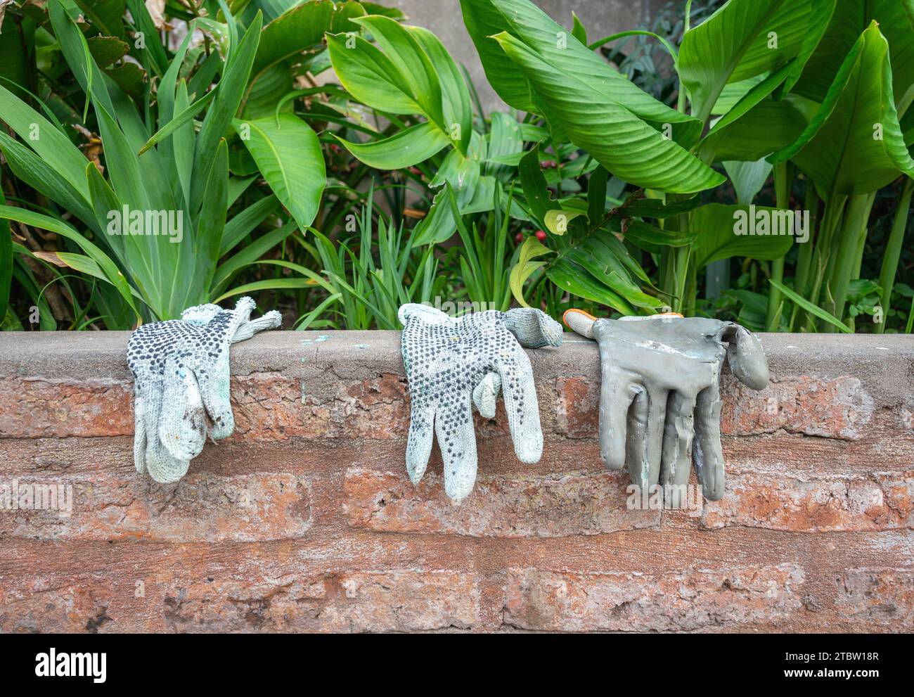 three work gloves worn from use Stock Photo Alamy
