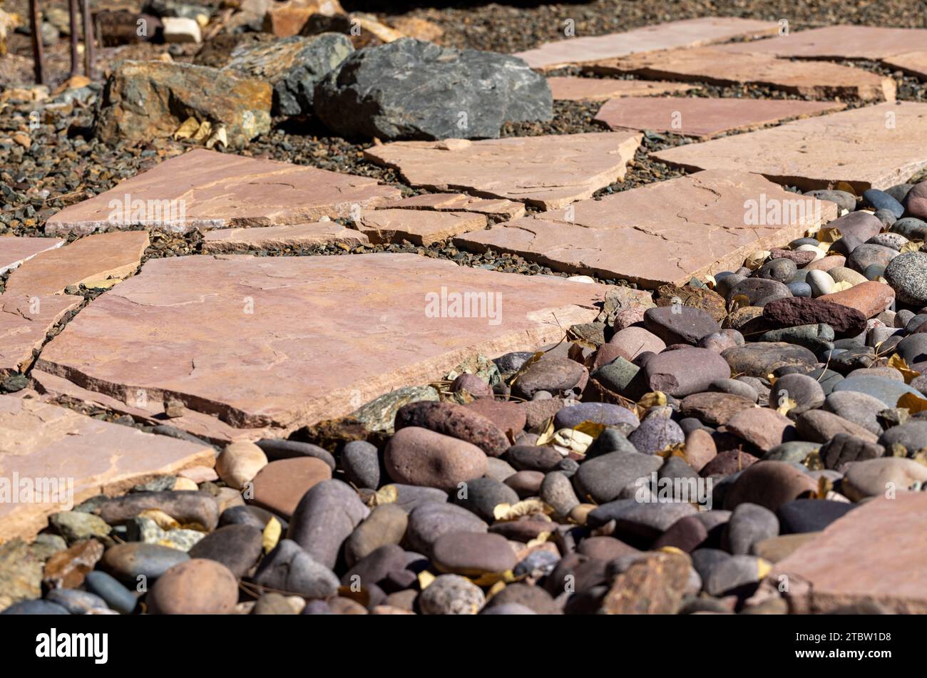 Yard landscape project with flagstone and gravel flooring installed Stock Photo