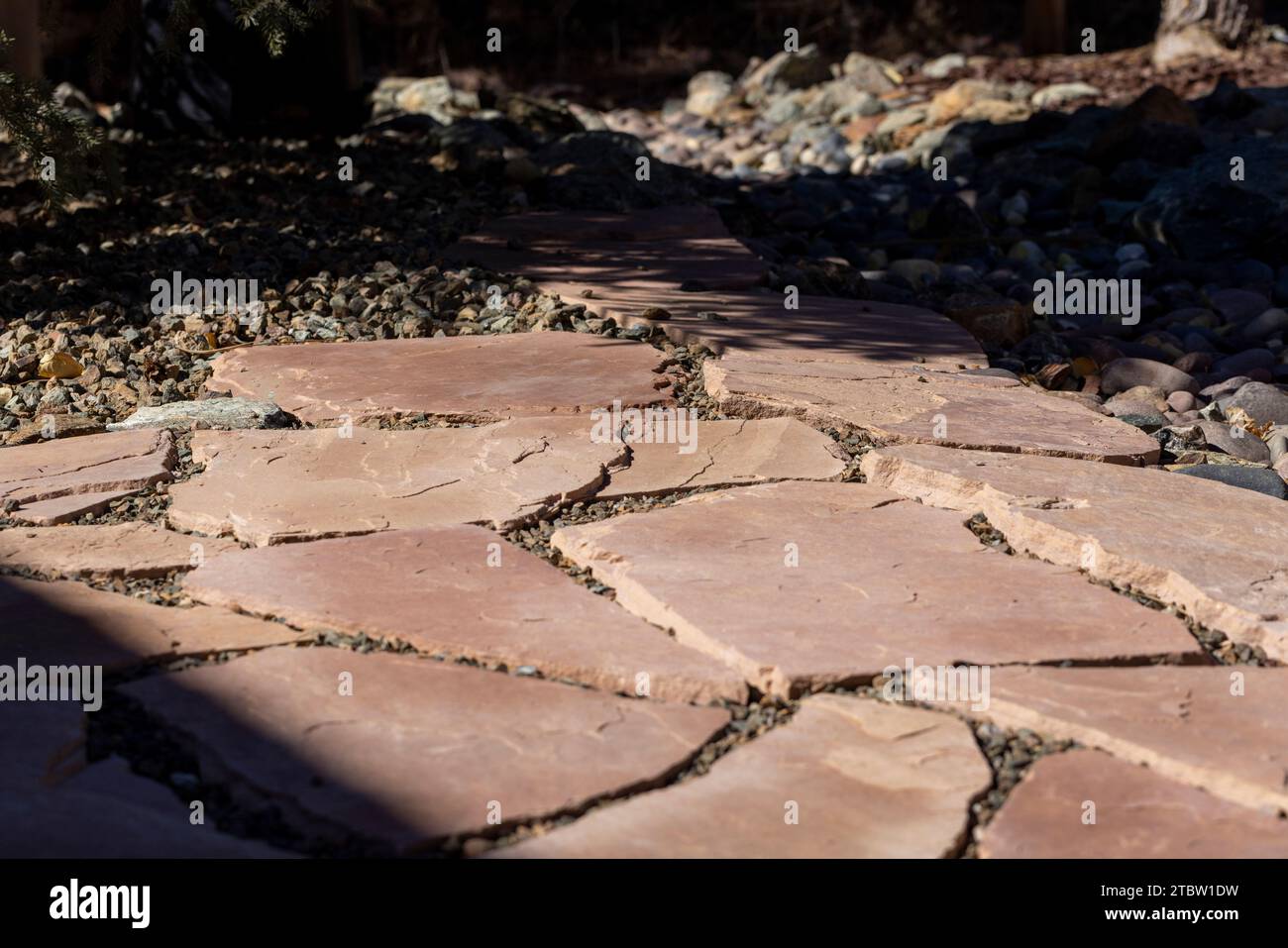 Yard landscape project with flagstone and gravel flooring installed Stock Photo