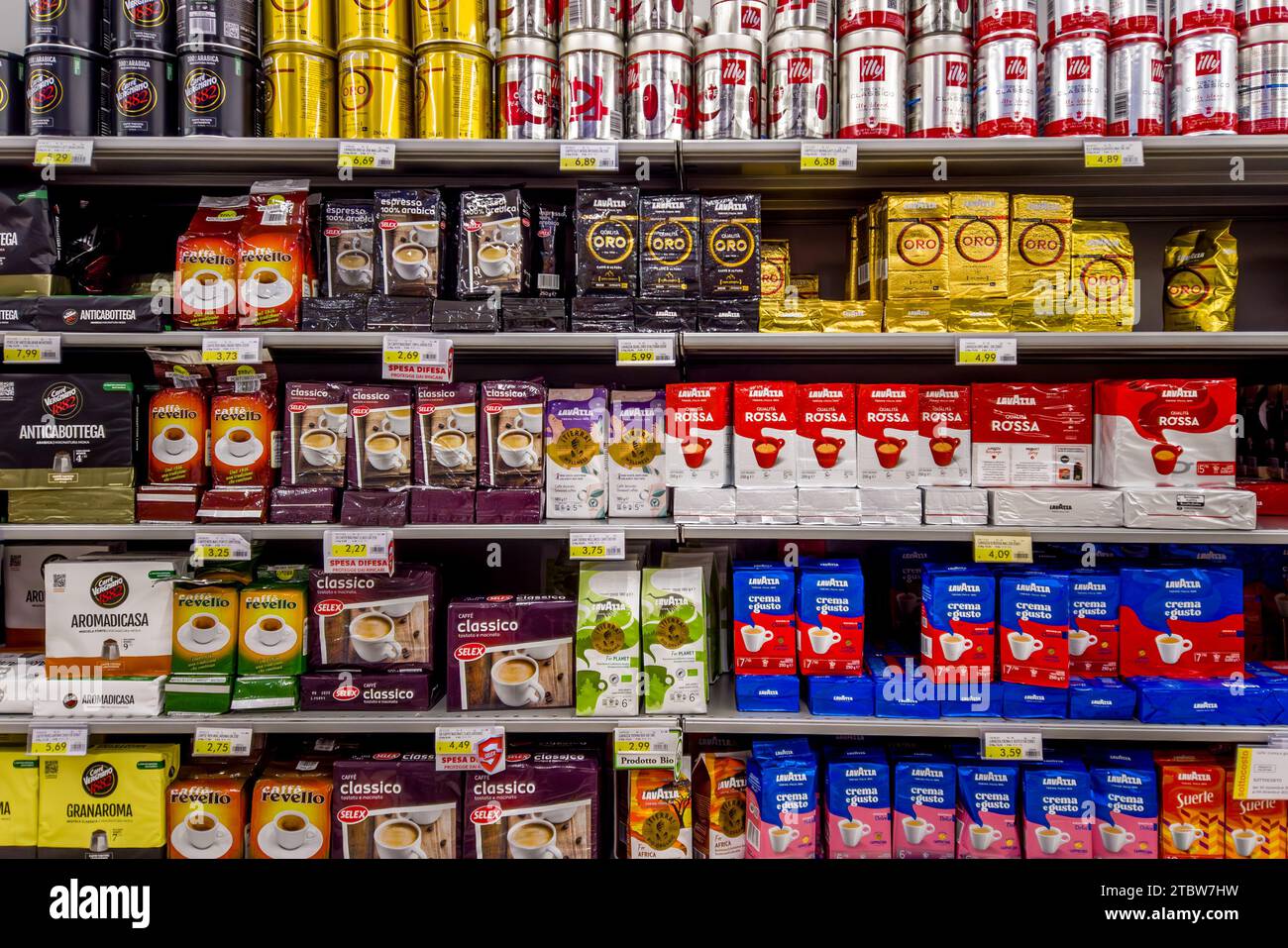 Italy - November 29, 2023: Ground coffee in packages of various types and brands displayed on shelves for sale in Italian supermarket Stock Photo