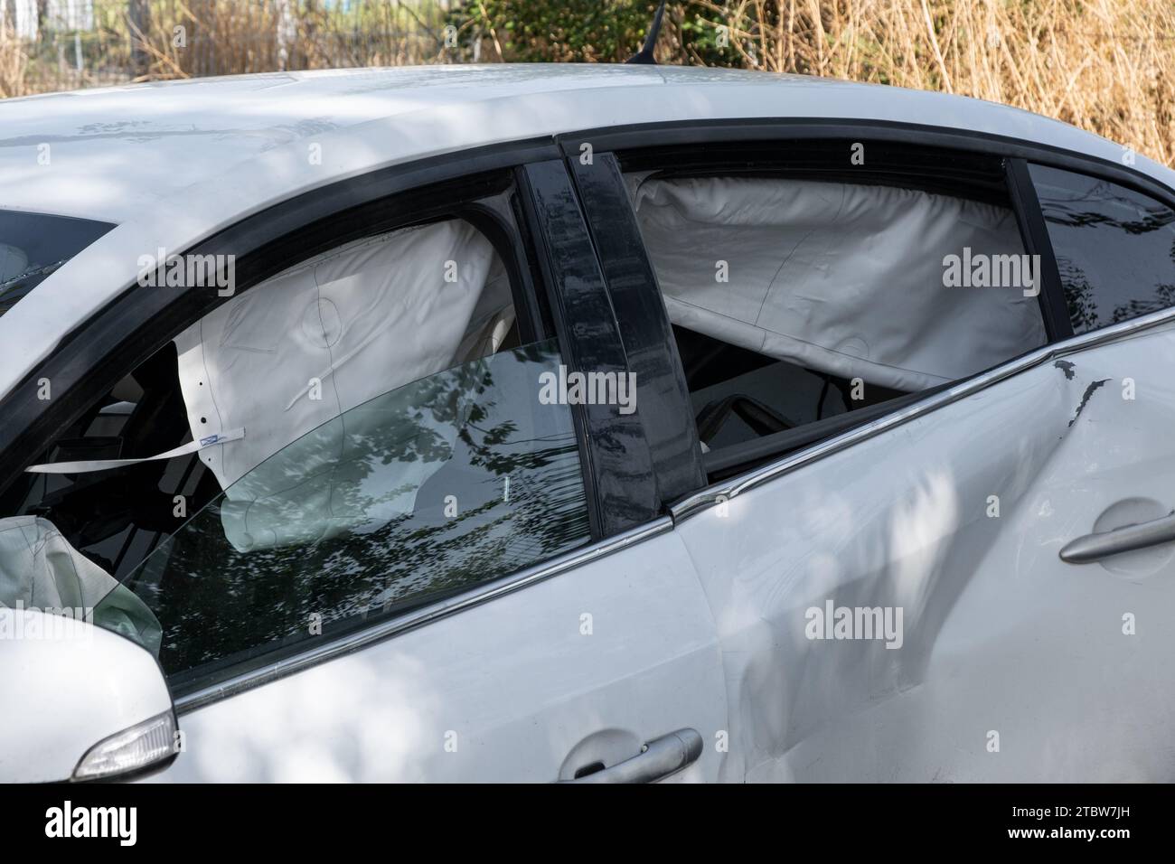 The car after a side impact deployed opened side airbags. Fast driving