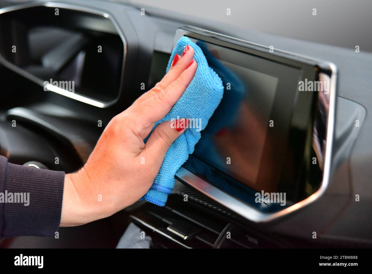 Cleaning the car console with a microfiber cloth Stock Photo - Alamy