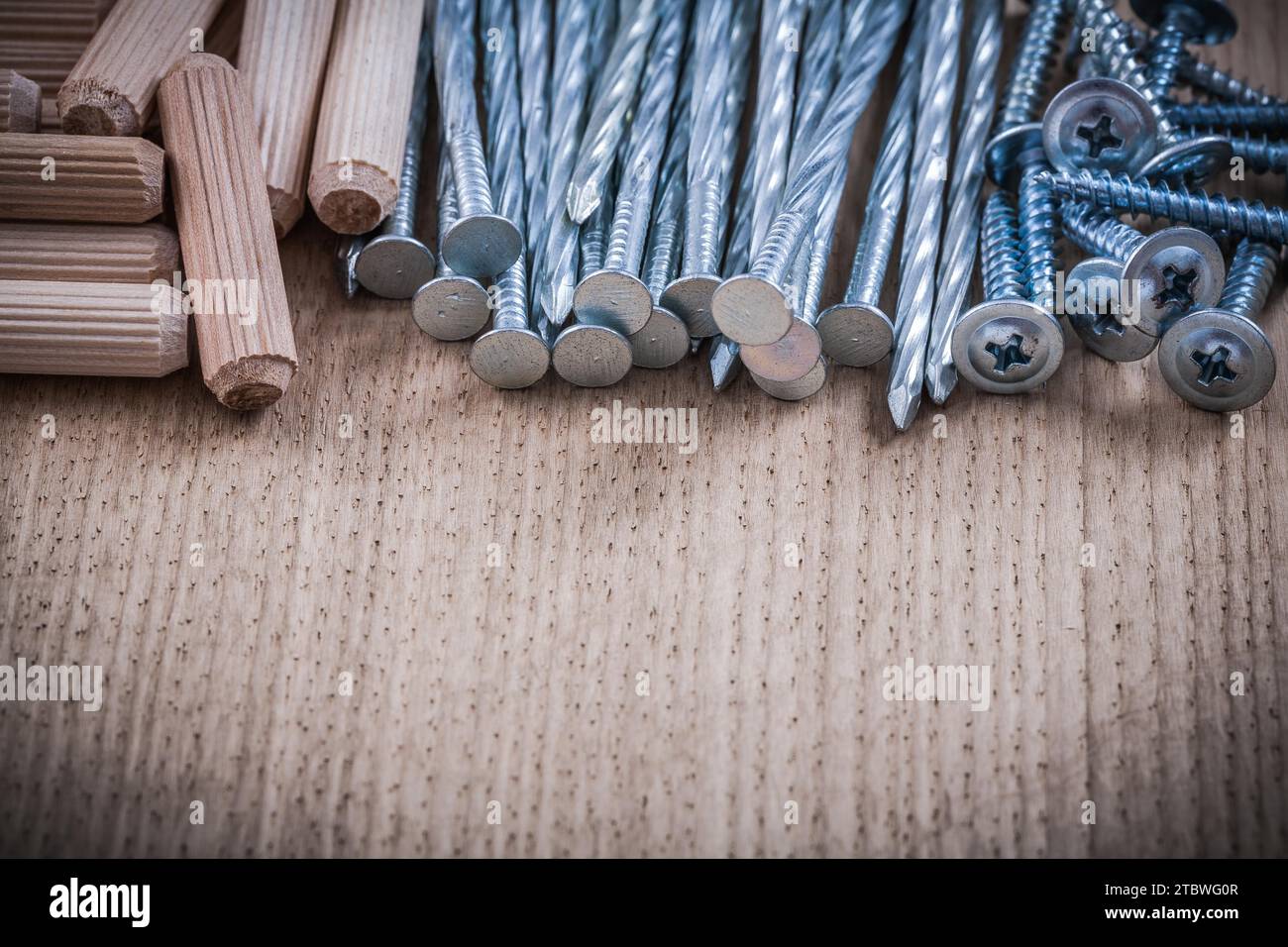 Variety of woodworking dowels and construction nails copy space image Stock Photo