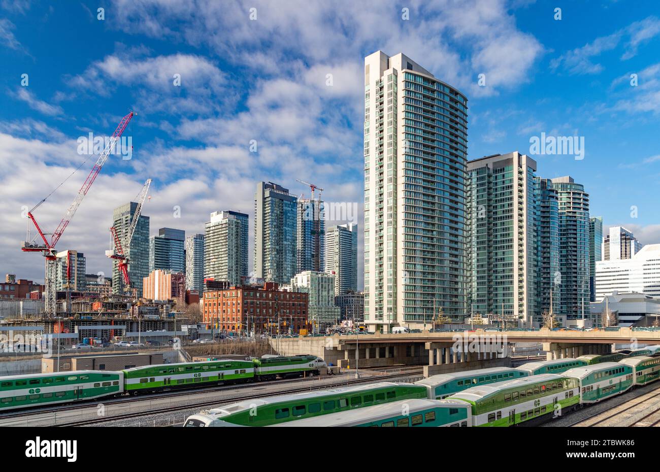A picture of many apartment buildings next to the railroad tracks, in