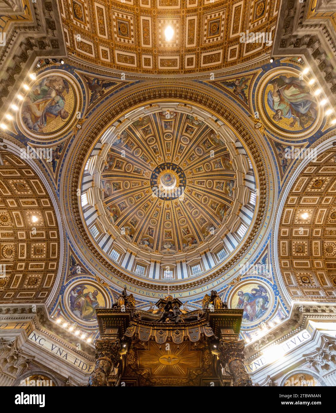A picture of the huge dome of the St. Peter's Basilica, the altar and the surrounding frescoes and architecture as seen from the inside Stock Photo