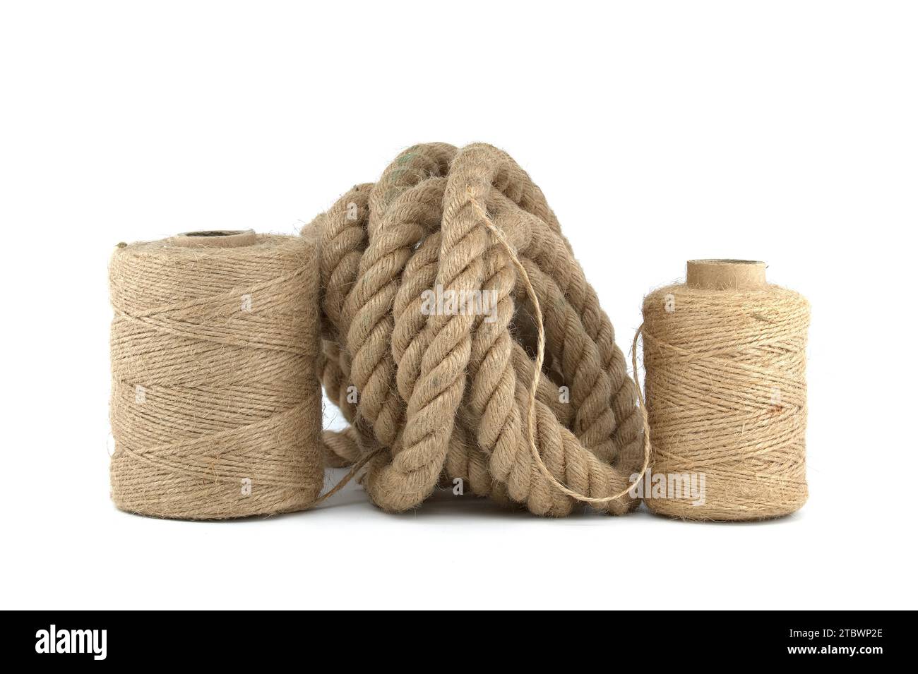 Jute rope and spools of burlap threads or jute twine in closeup over a