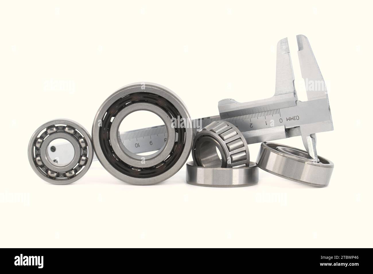 Measure caliper and roller bearings on white background. Mechanical engineering and automotive industry Stock Photo