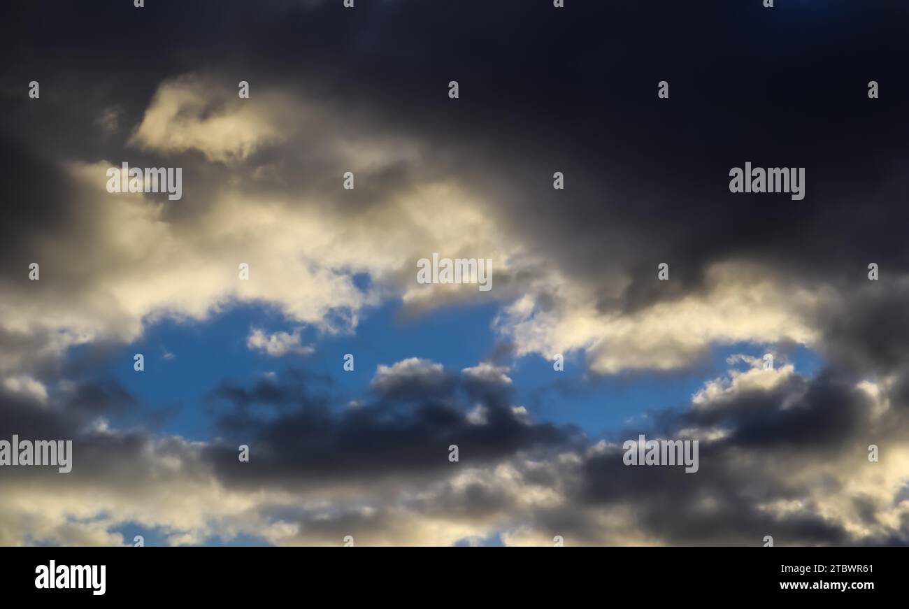 Blue sky and dark clouds with sunlight Stock Photo