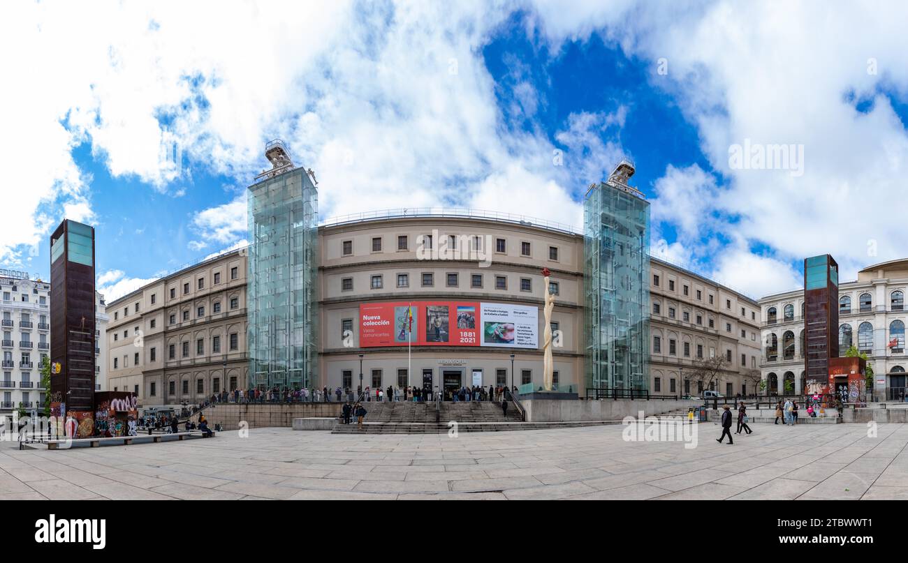 A panorama picture of the Museo Nacional Centro de Arte Reina Sofia's main facade with visitors queuing up Stock Photo