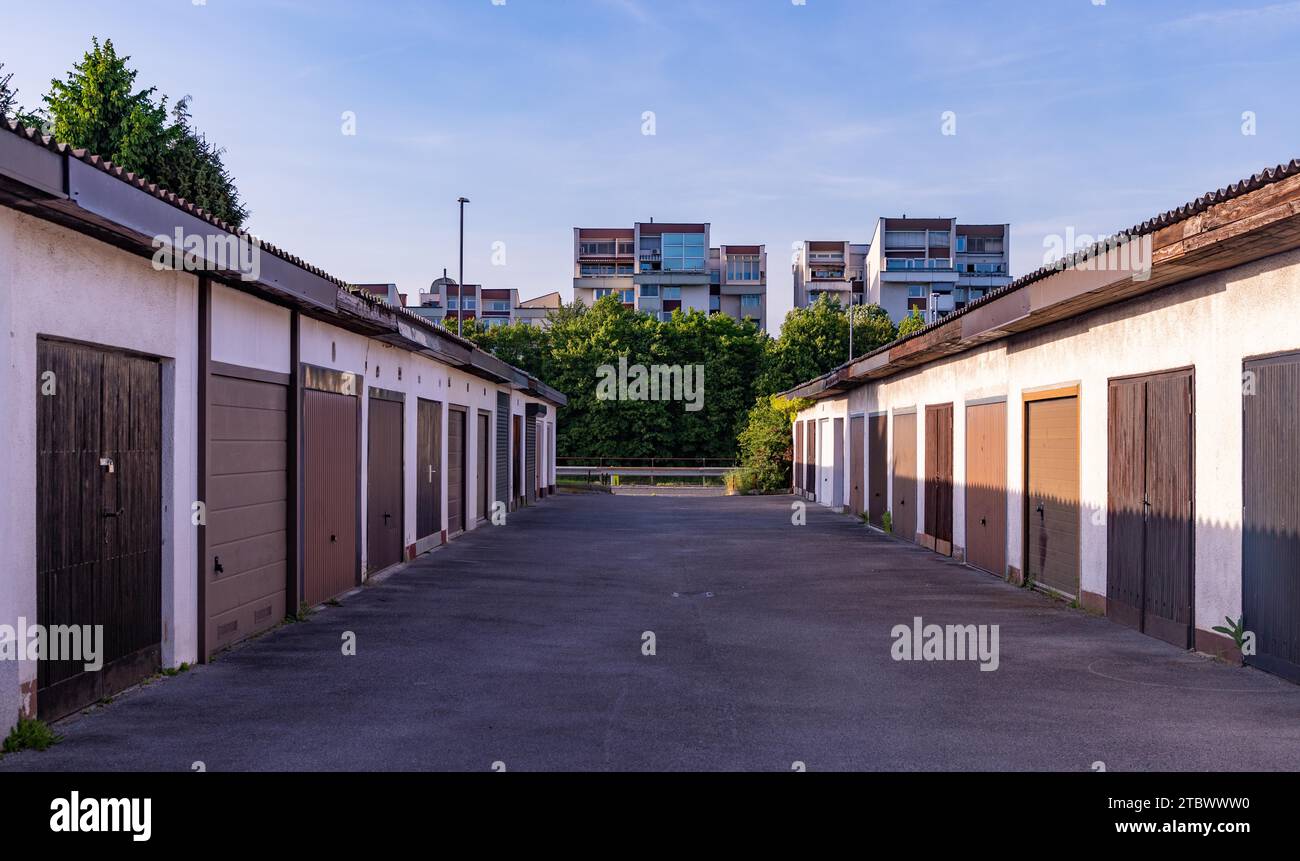 A picture of a small road lined by small individual garages Stock Photo