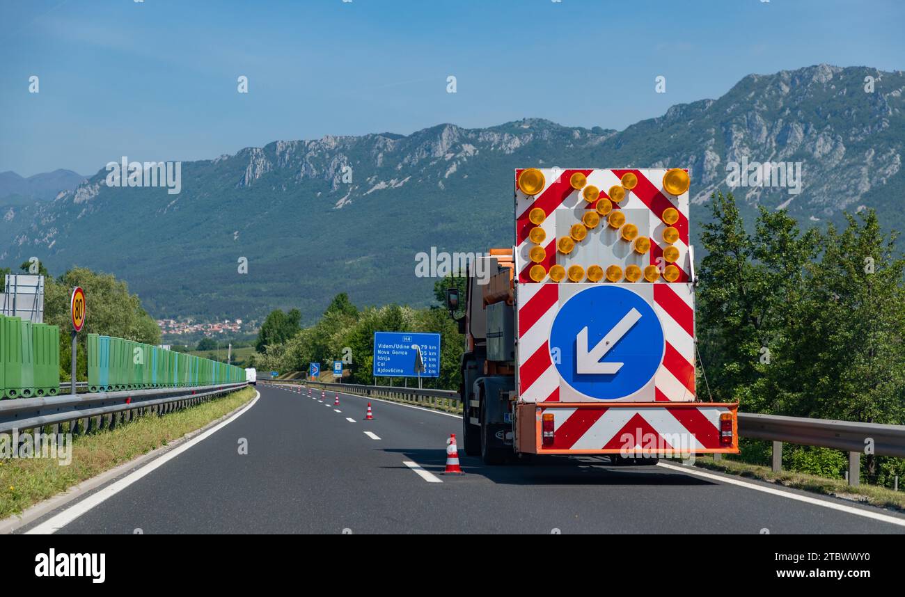 A picture of an arrow pointing to a construction area ahead on a Slovenian highway Stock Photo