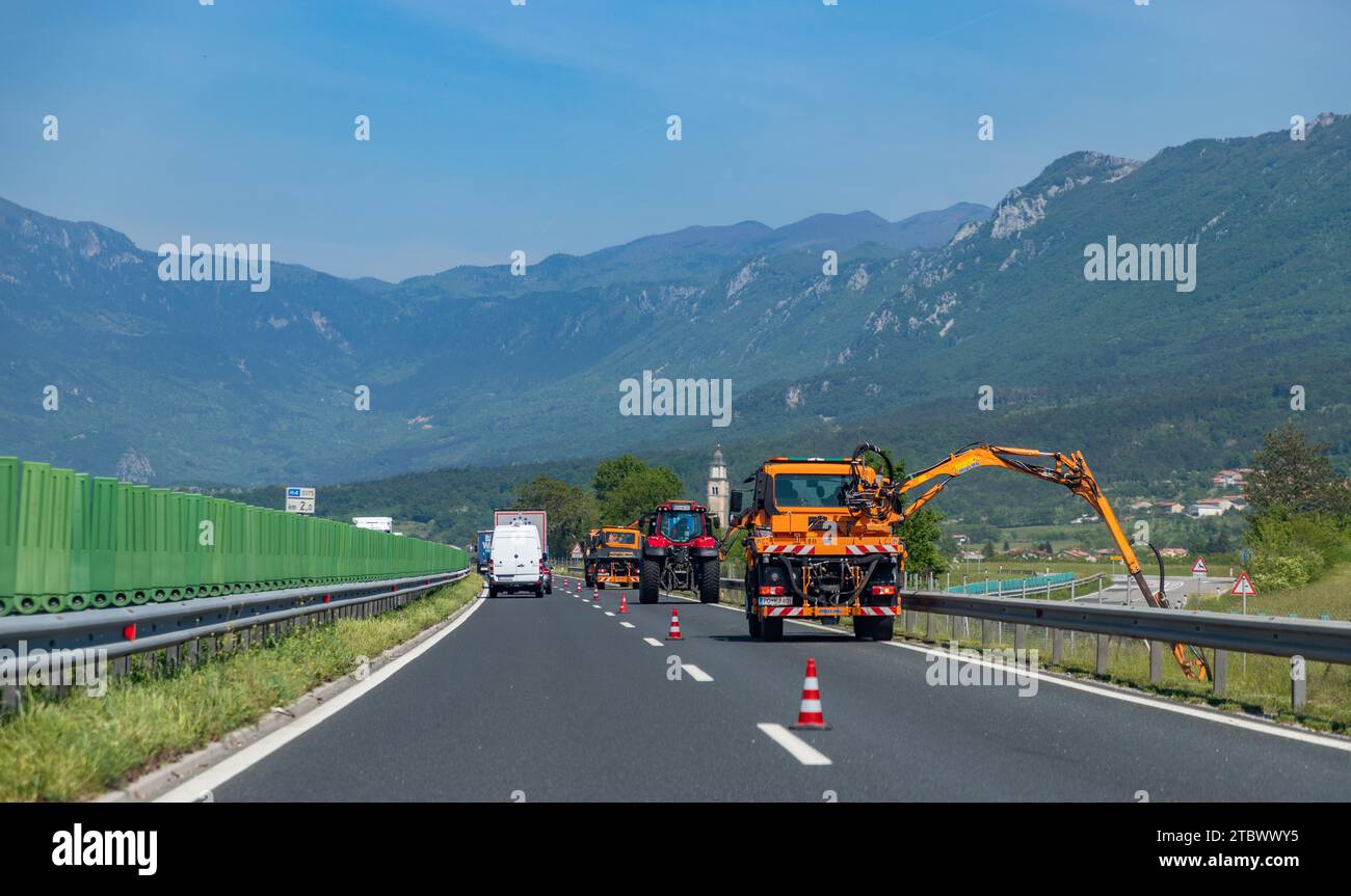 A picture of roadside works being done by special machinery on a Slovenian highway Stock Photo