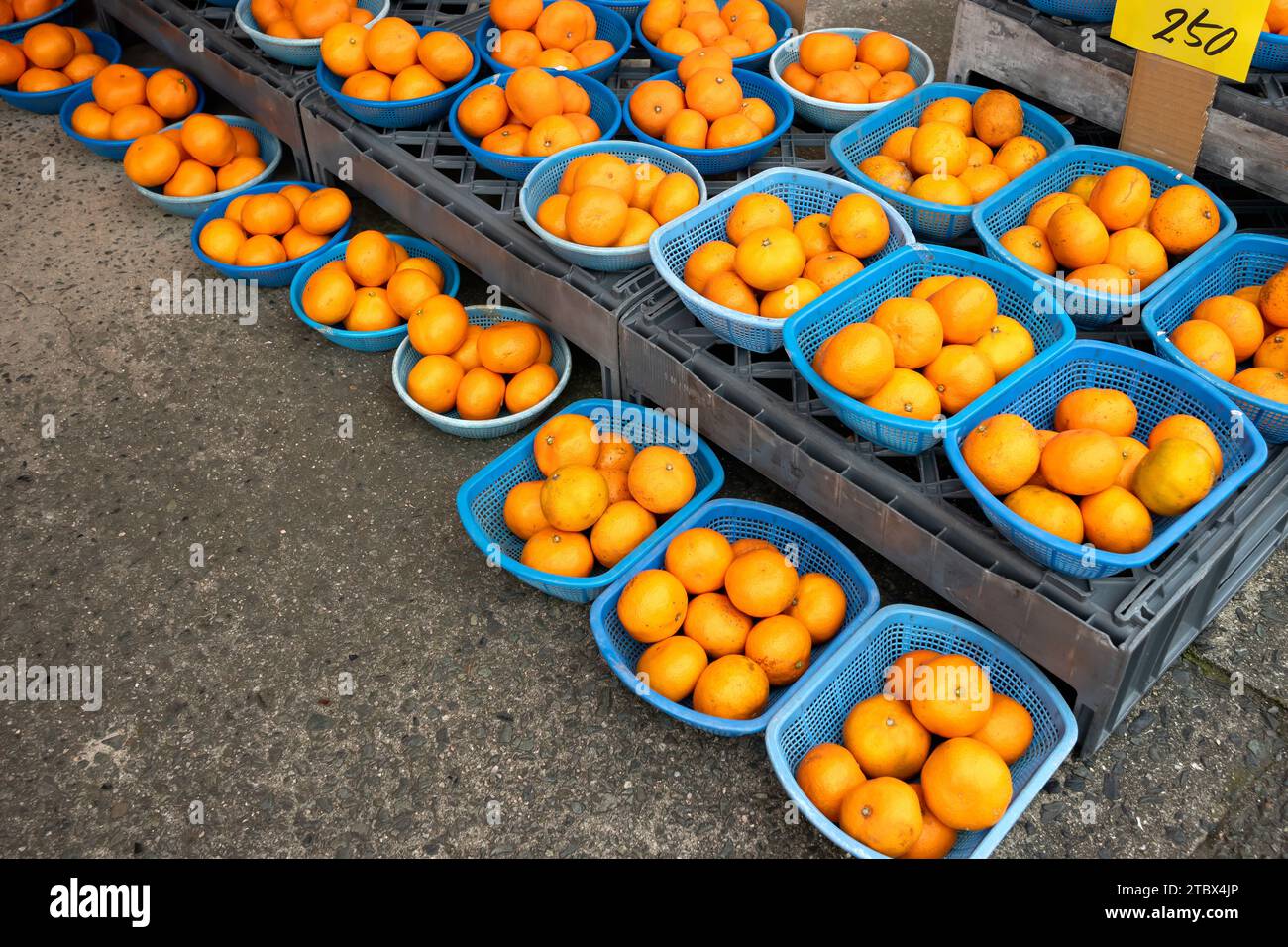 Bunch of oranges in baskets sold at a local street market in Japan. Stock Photo