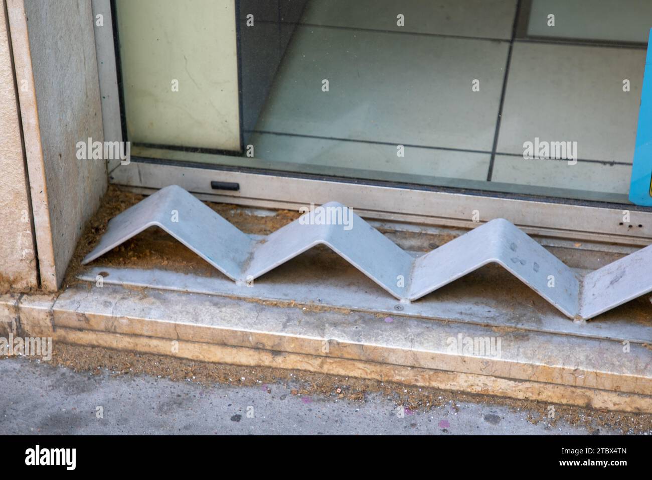 hostile design steel mounted on the edge of the curb prevents the