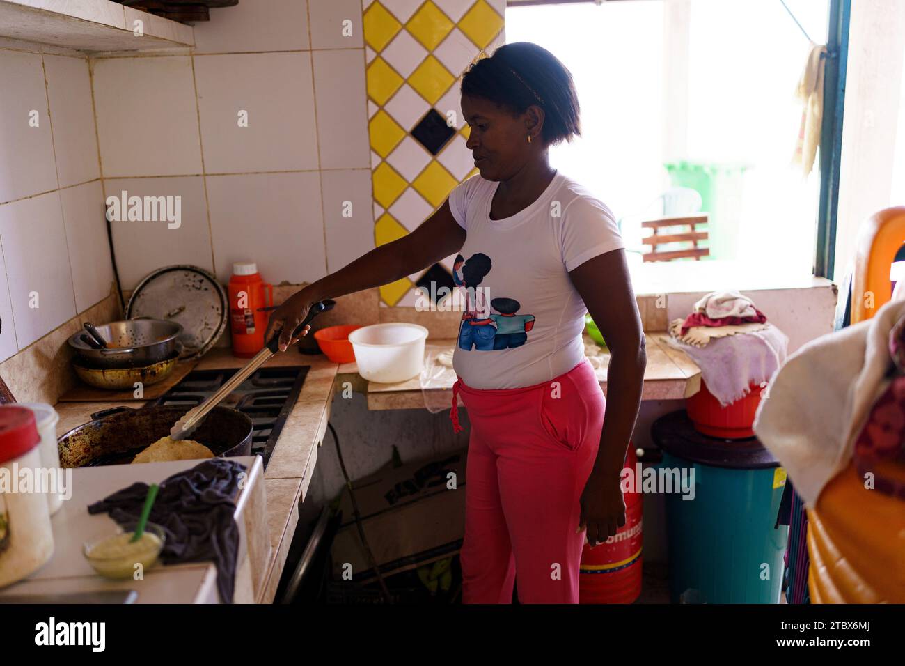 A local woman is seen preparing traditional empanadas in her house. Even though restrictions on currency exchange have been eased and most transaction are now carried out in US dollars, Venezuela's economy is still in dire straits with an annual inflation of 398% and a 7% decrease in economic activity, with many people struggling to reach the end of the month. Stock Photo