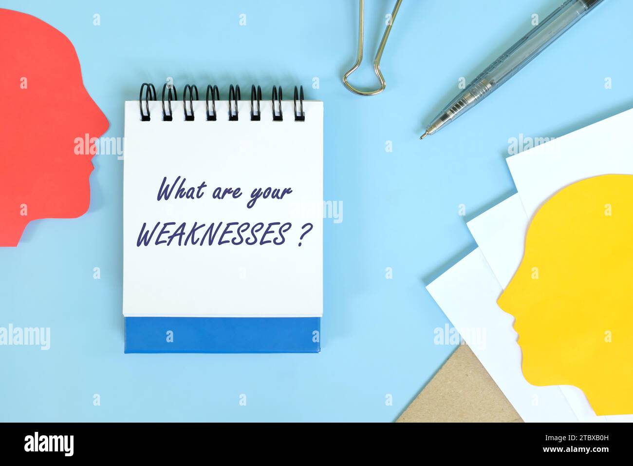 Self awareness and weakness personality concept. Office flat lay composition in blue background. Stock Photo