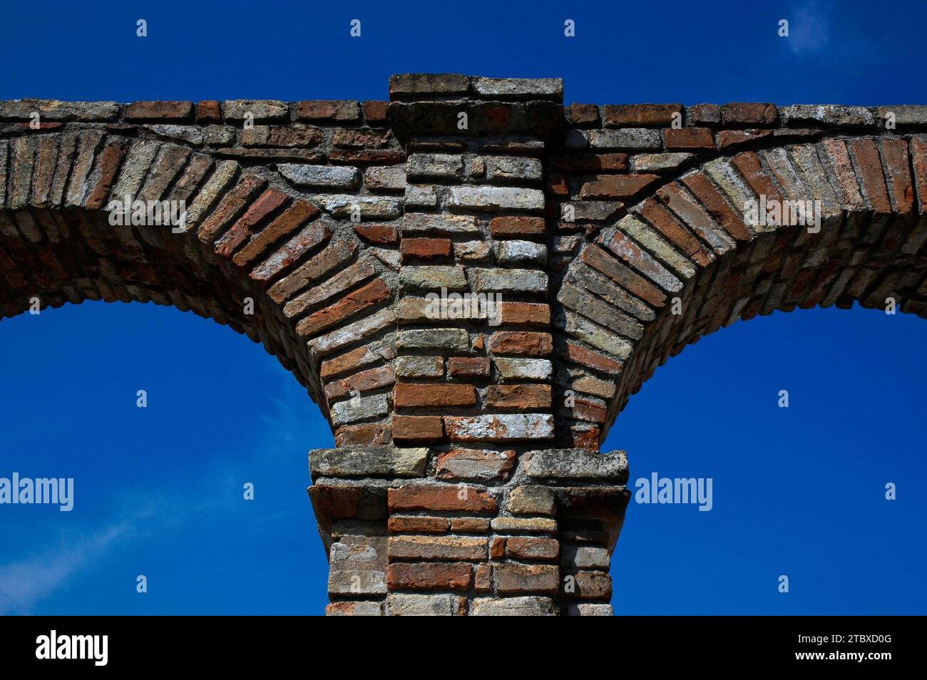 Section of brick arcade amid the ruins of the Grotte di Catullo or Grottoes of Catullus, an opulent Roman villa built in the 1st century BCE at Sirmione in Lombardy, Italy.  The ruins are on the headland tip of the Sirmio peninsula, a promontory at the southern end of Lake Garda. Stock Photo