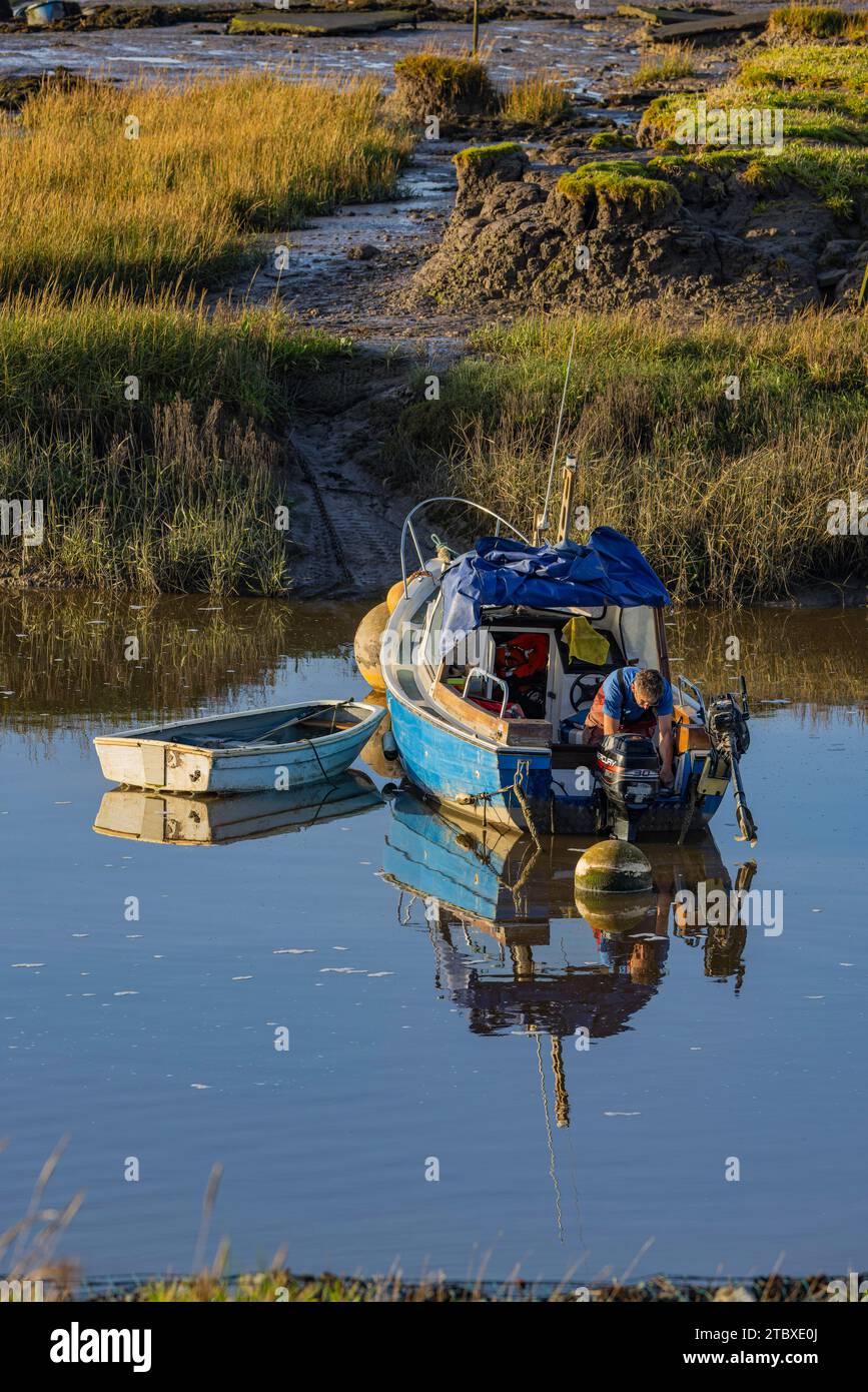 A man doing some repair work on his boat Stock Photo