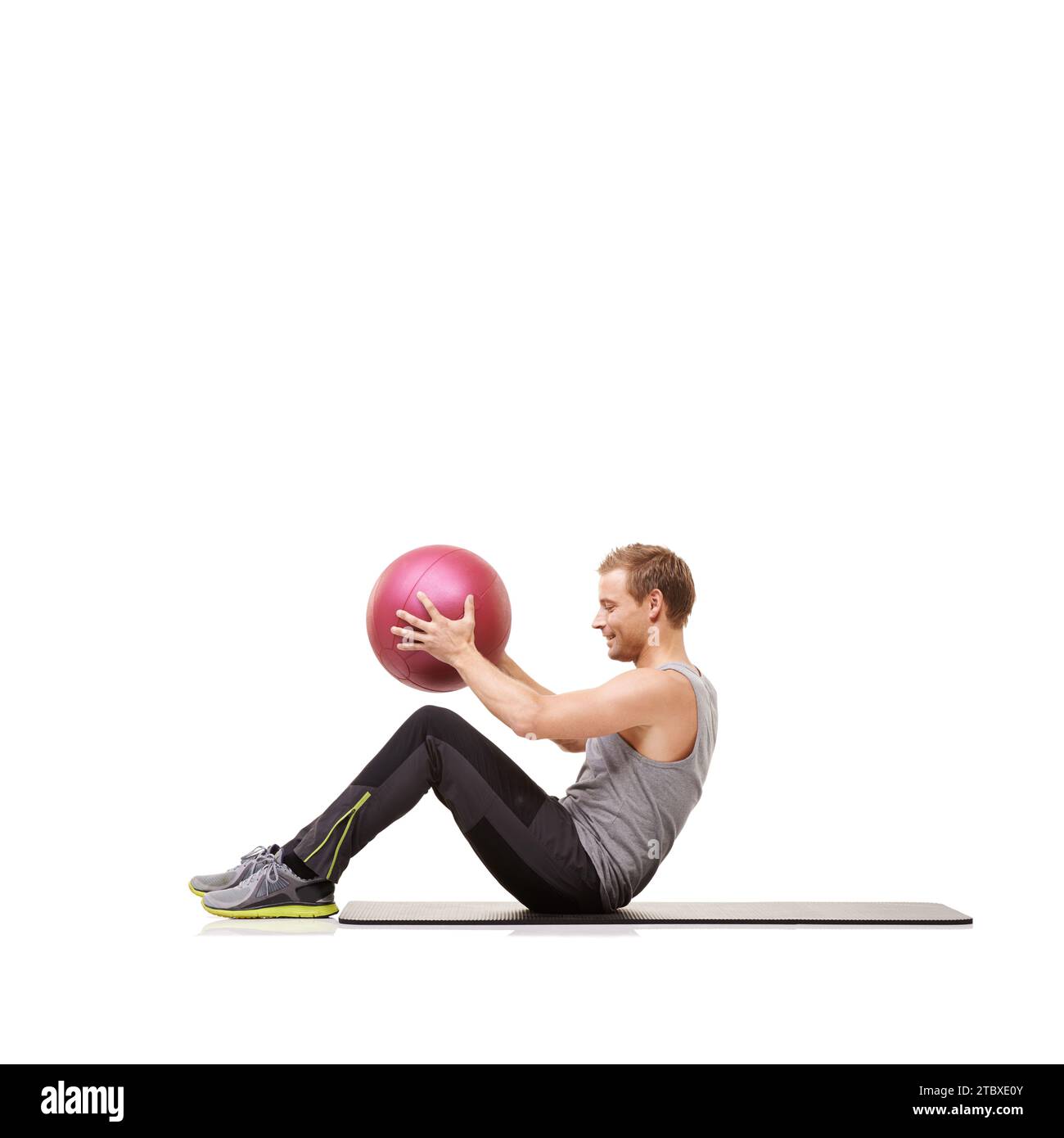 Man, medicine ball and sit up for training workout in studio on white