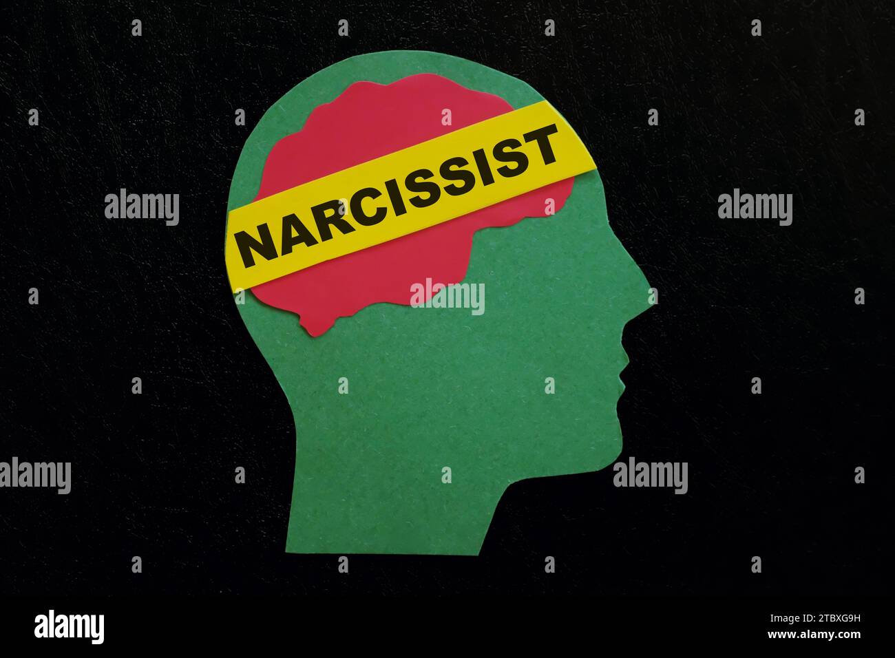 Human head profile with word narcissist in dark black background.