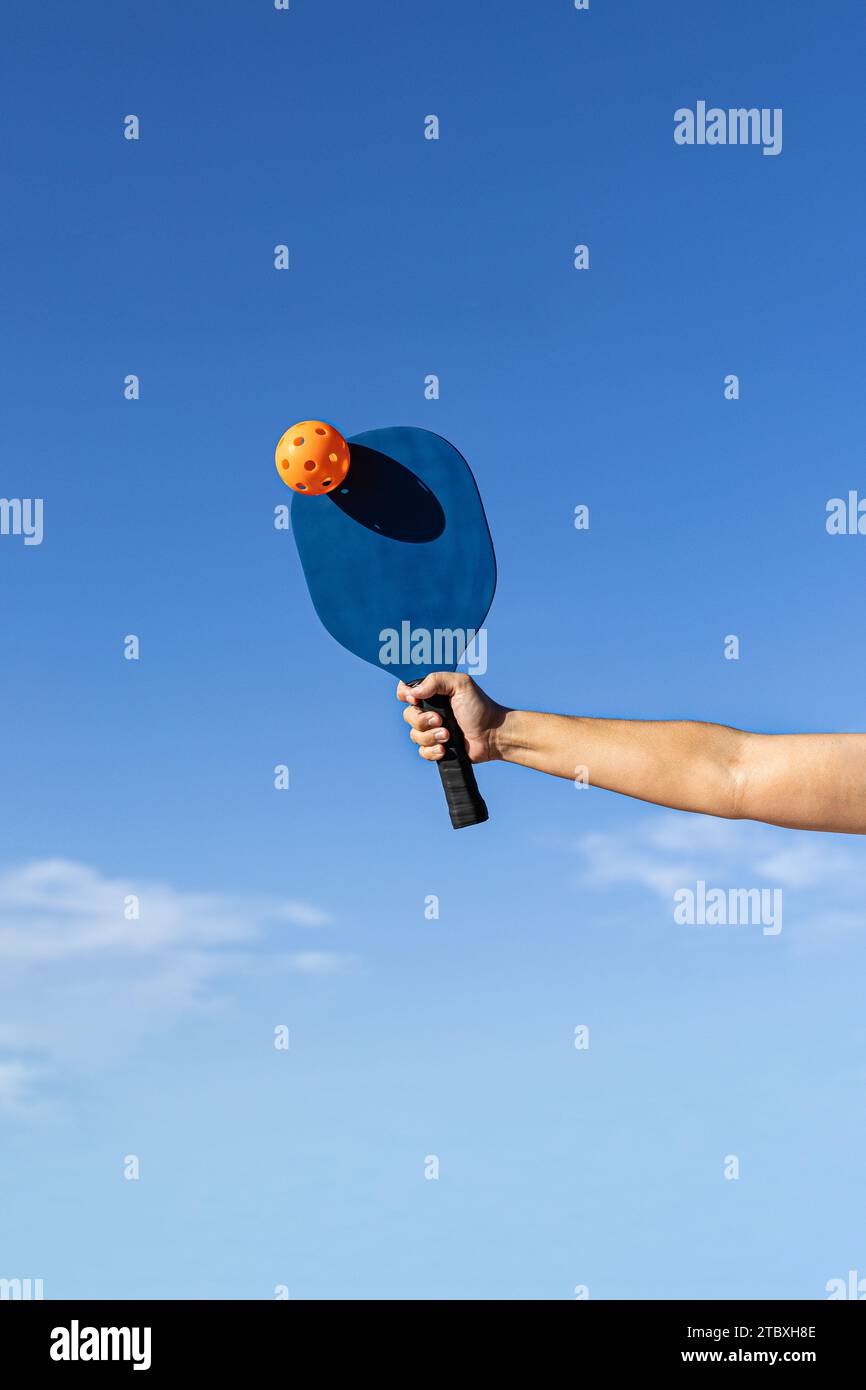 Pickleball player hitting the ball in the middle of a game Stock Photo