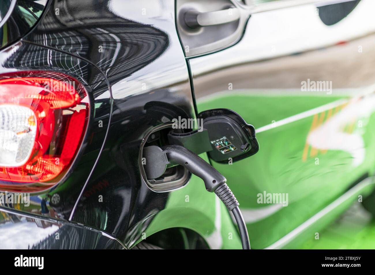 Charging battery of an electric car at charge station Stock Photo