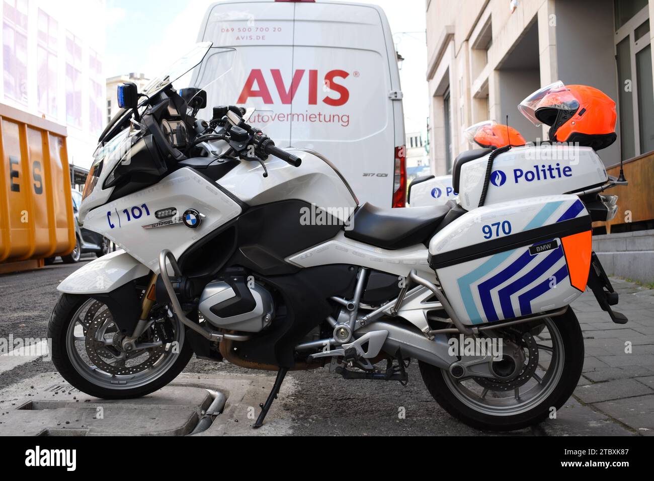 Side view of a Belgian police motorcycle with orange helmet Stock Photo