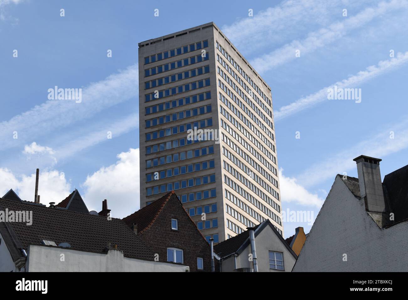 The large Sablon tower standing high above the houses of the Sablon quarter in the centre of Brussels on a sunny day Stock Photo