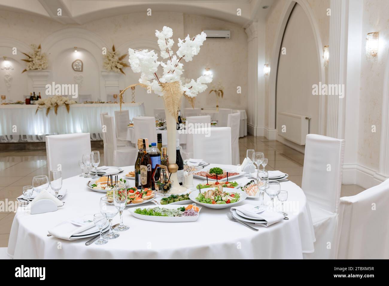 Ivano-Frankivsk, Ukraine 8 September 2023:Decoration and serving of the festive table in the restaurant, white tablecloths and ready-made snacks and d Stock Photo