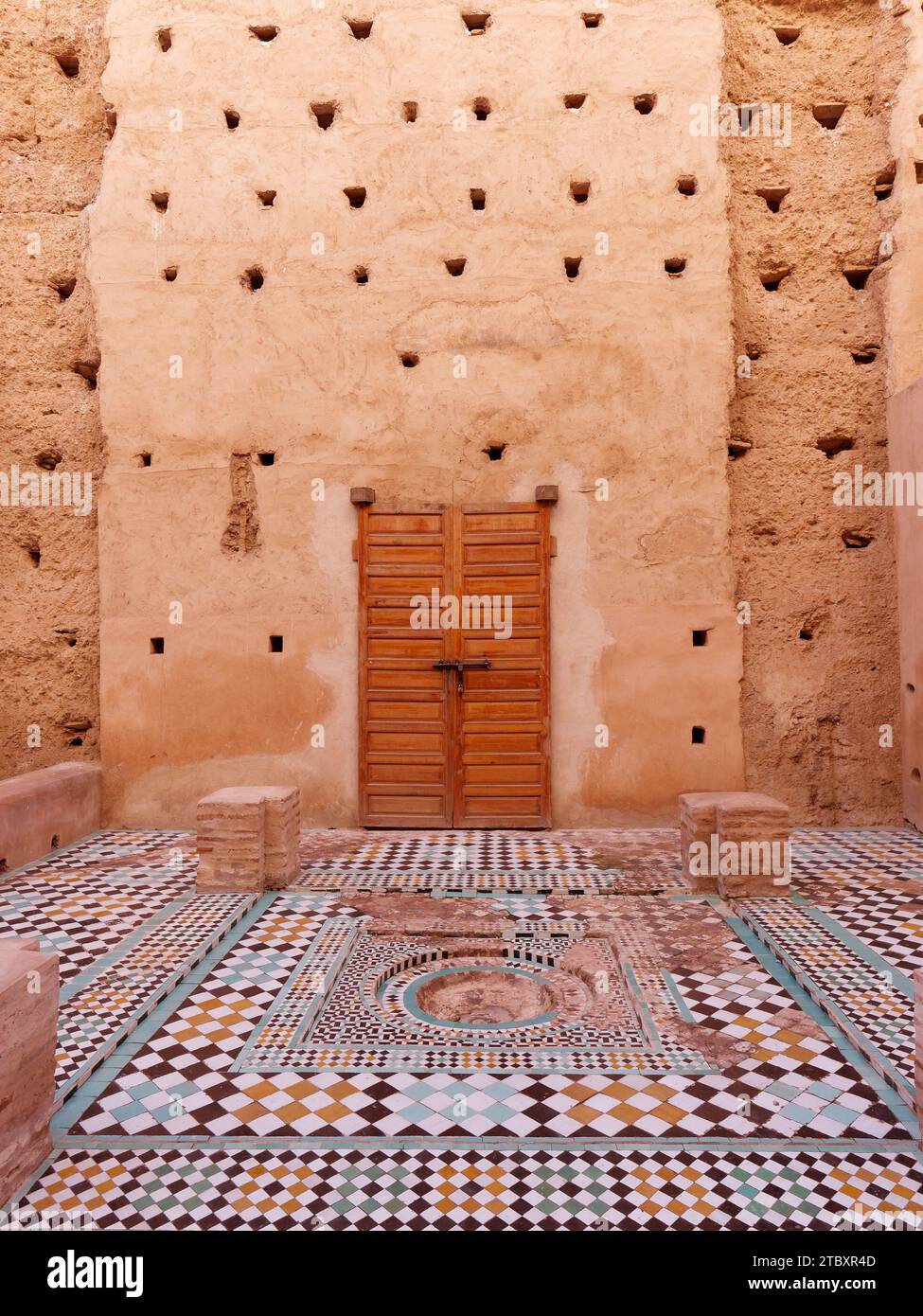 Courtyard with high earthen walls with tiled floors in Badi Palace in the city of Marrakesh aka Marrakech, Morocco, December 09, 2023 Stock Photo