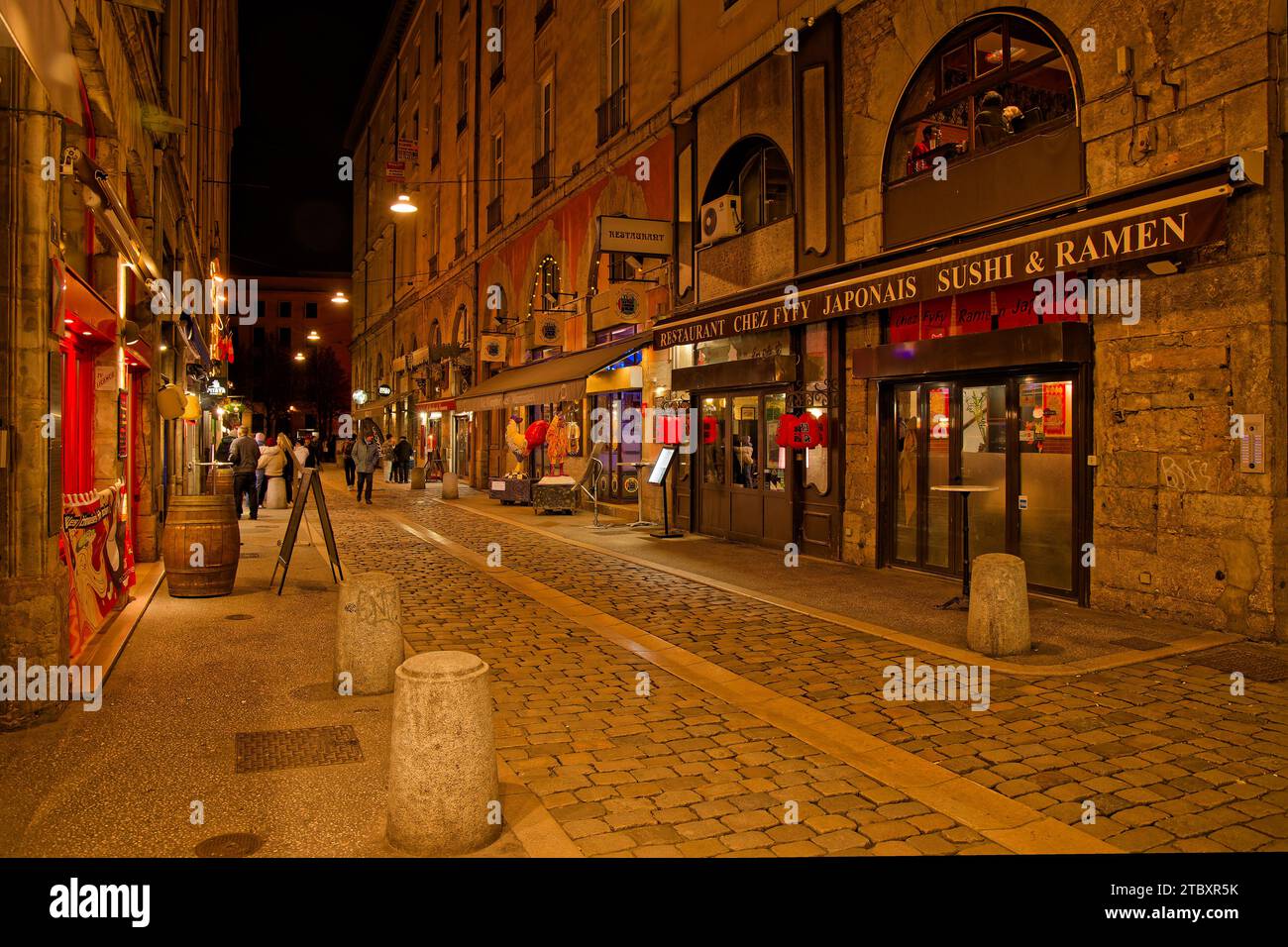 LYON, FRANCE, December 7, 2023 : Night on Rue des Marroniers, a well-known street for its numerous bouchons lyonnais, traditional restaurants of the c Stock Photo
