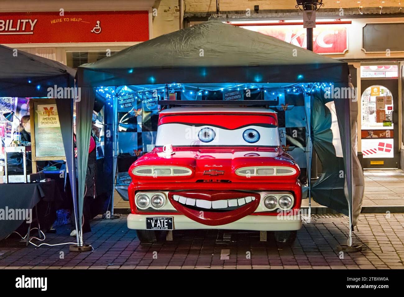 A red truck decorated with a smiling face at the evening Christmas Market in Boston Stock Photo