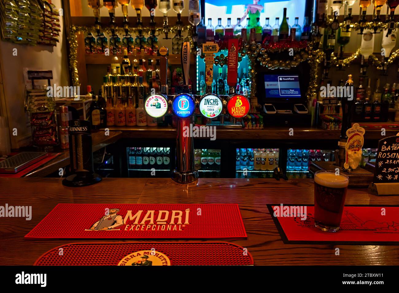 The bar inside the Britannia pub with drink brands displayed Stock Photo