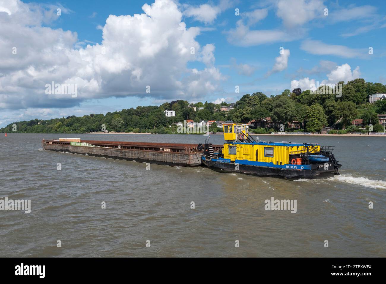 The Schub Express 10 inland pushboat pushing a large barge along the River Elbe, viewed from the 62 HADAG ferry in Hamburg, Germany. Stock Photo