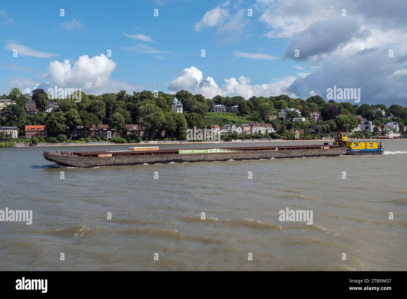 The Schub Express 10 inland pushboat pushing a large barge along the River Elbe, viewed from the 62 HADAG ferry in Hamburg, Germany. Stock Photo
