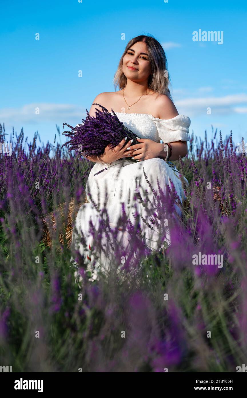 Ivano-Frankivsk, Ukraine August 2, 2023: A girl with a fragrant lavender bouquet, aromatherapy on a lavender field. Stock Photo