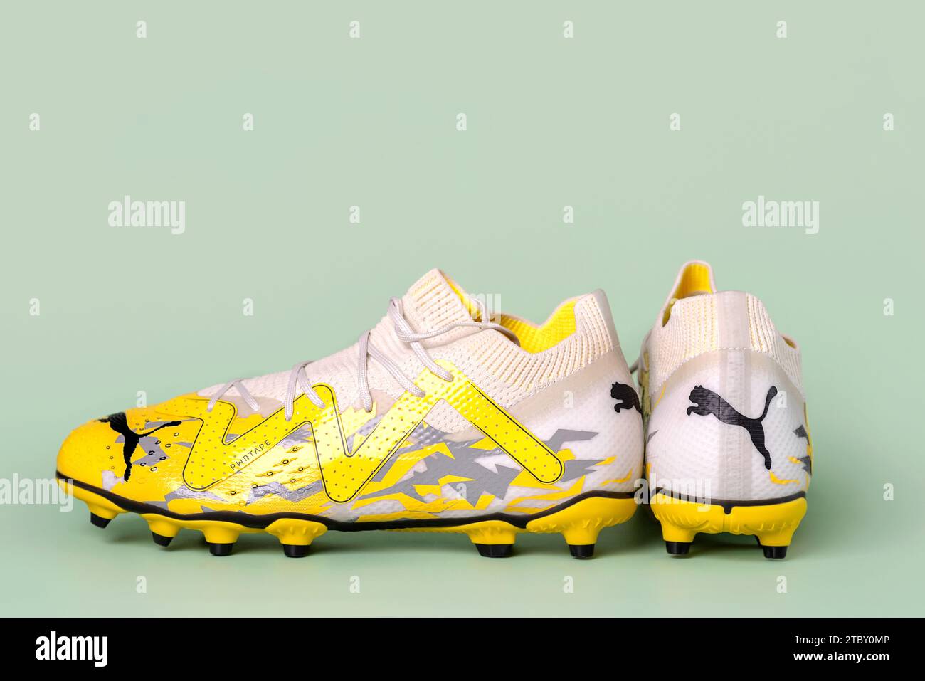 Puma Future Pro football boots over green background. Puma soccer shoes Illustrative editorial Stock Photo