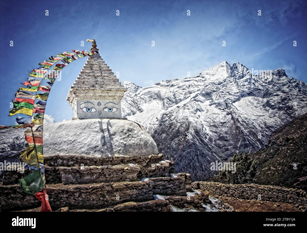 A stupa sits above the town of Namche with Kongde towering in the backgroud, Nepal. Stock Photo