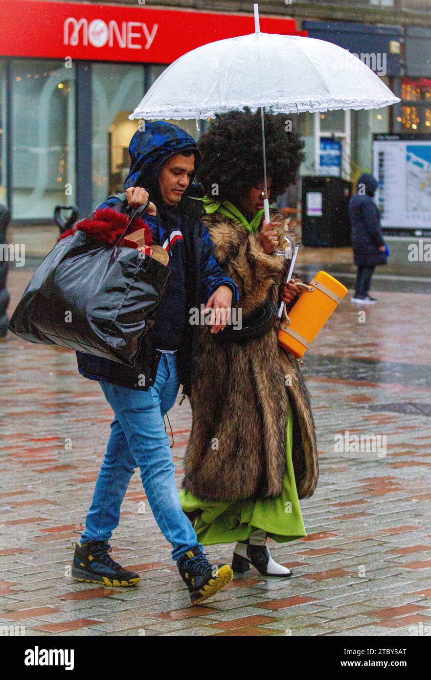 Dundee, Tayside, Scotland, UK. 9th Dec, 2023. UK Weather: A rain warning is in effect as heavy rain continues to keep falling across Northeast Scotland. Dundee locals go Christmas shopping in the city centre over the weekend, wrapped up against the bitter cold and torrential downpours. Credit: Dundee Photographics/Alamy Live News Stock Photo