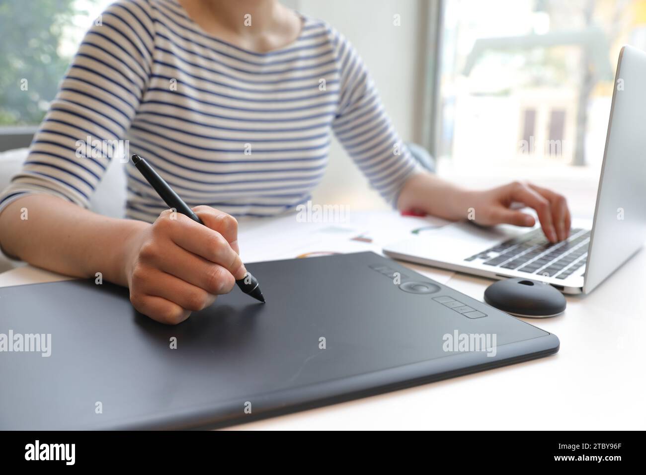 Woman who creates NFT works using tablet Stock Photo
