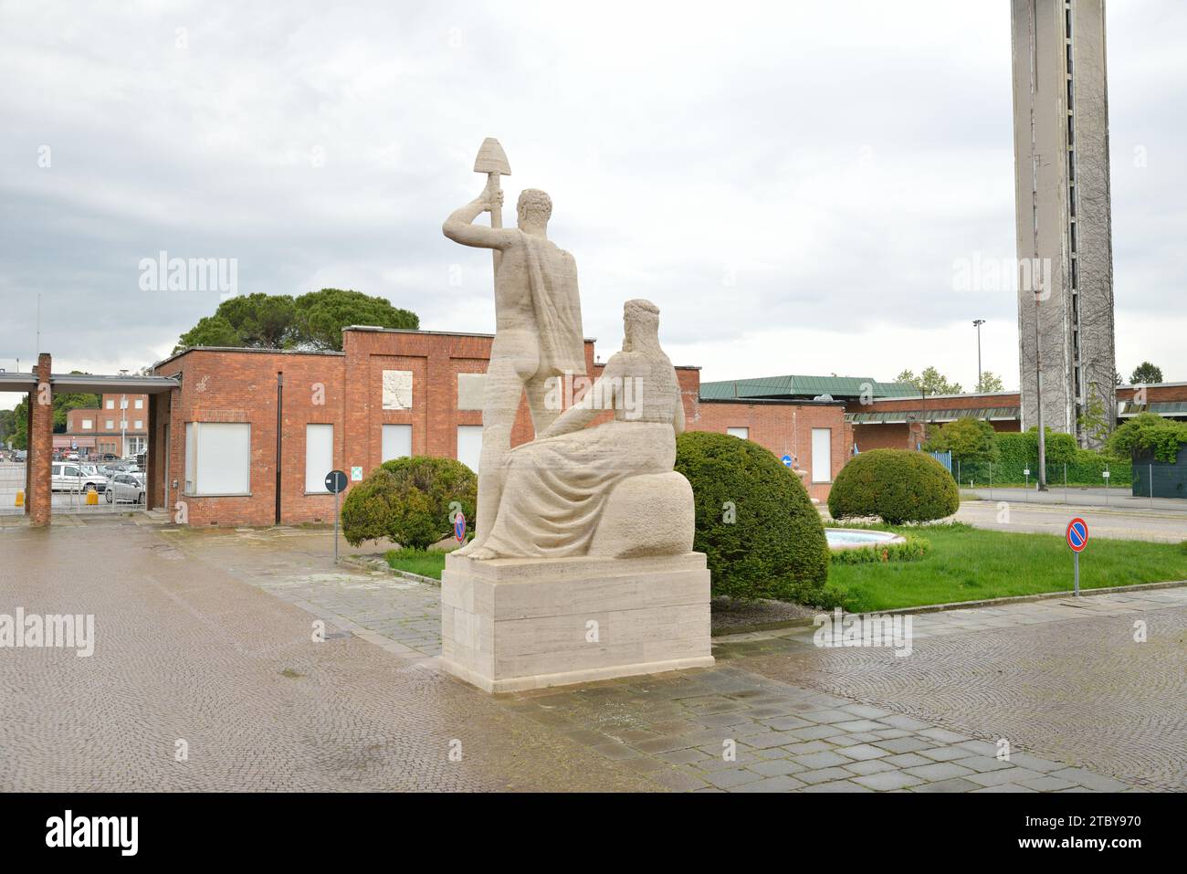 Torviscosa, Italy - The main building and rear side of statue located at the entrance Stock Photo