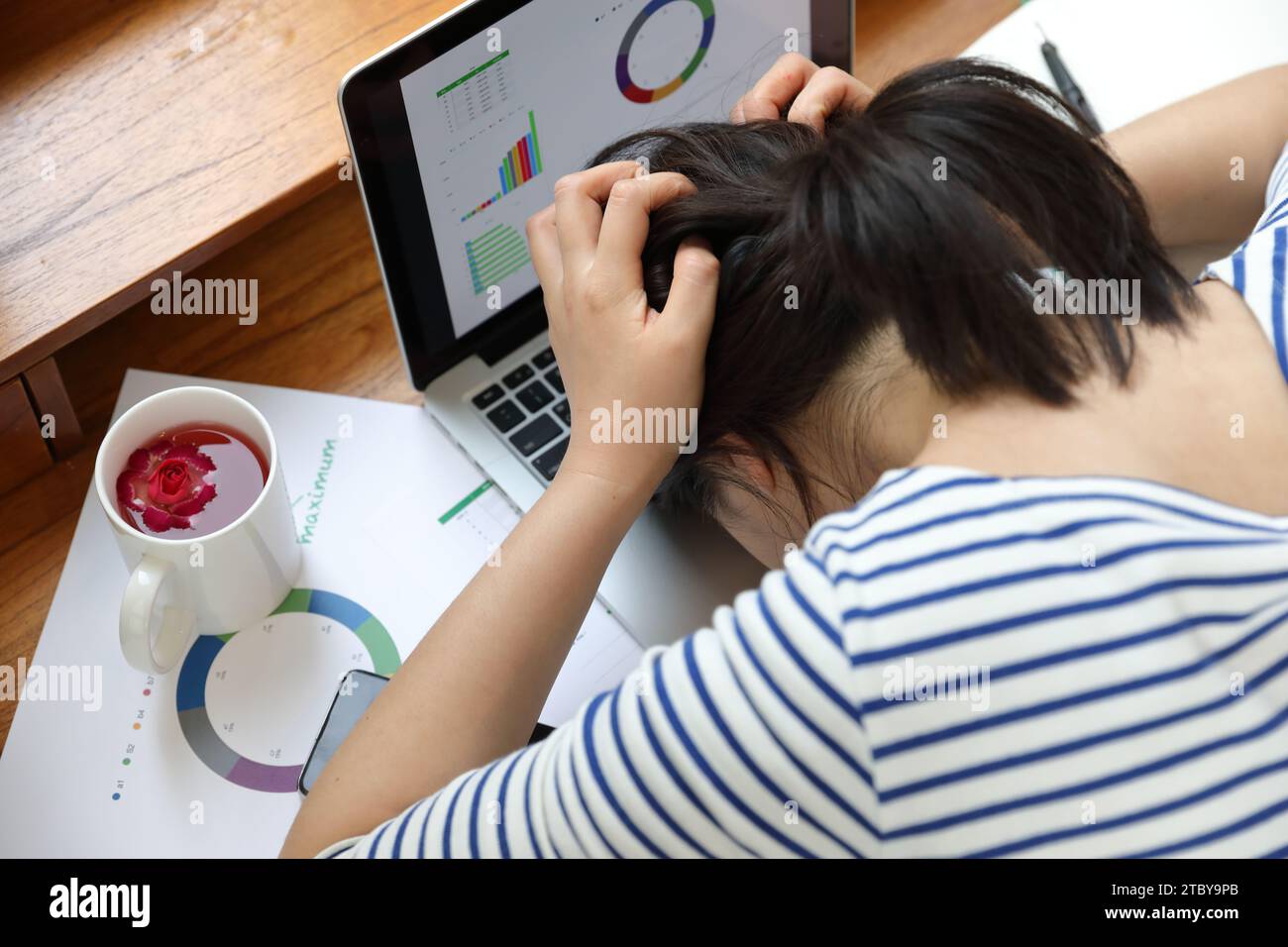Disappointed while working on the laptop, lying face down Stock Photo ...